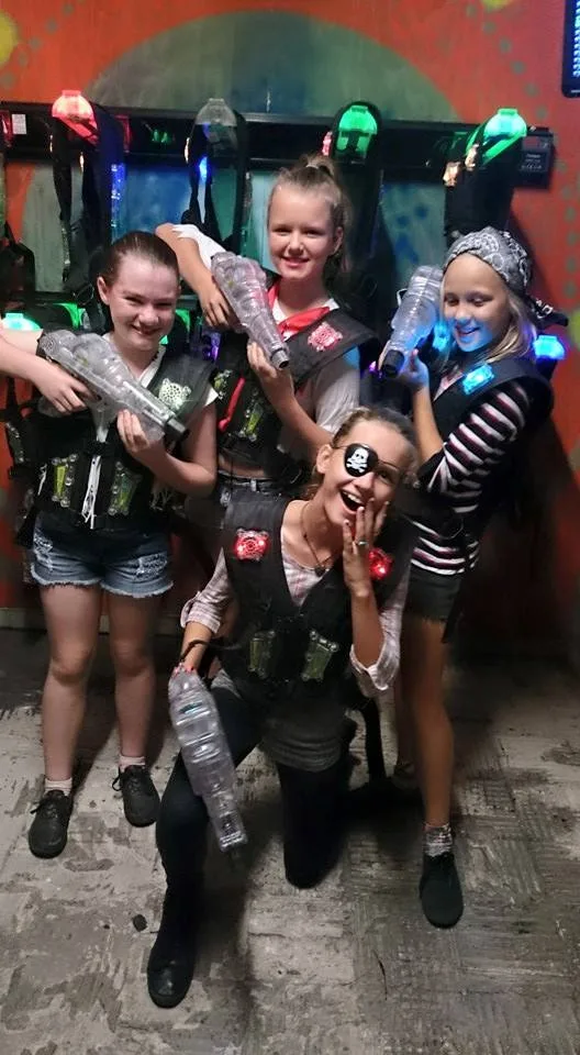 4 kids, posing with laser tag vests on